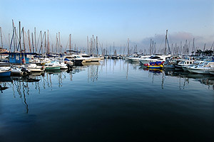 Reflections of boats in a harbor along the French Riviera